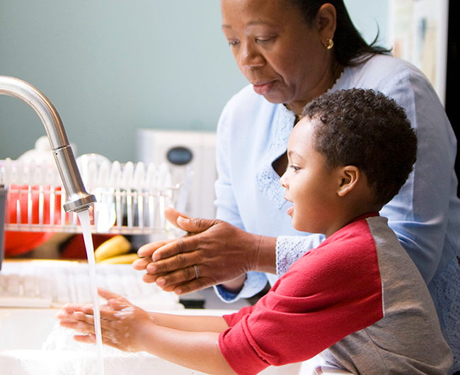 mom and son washing hands