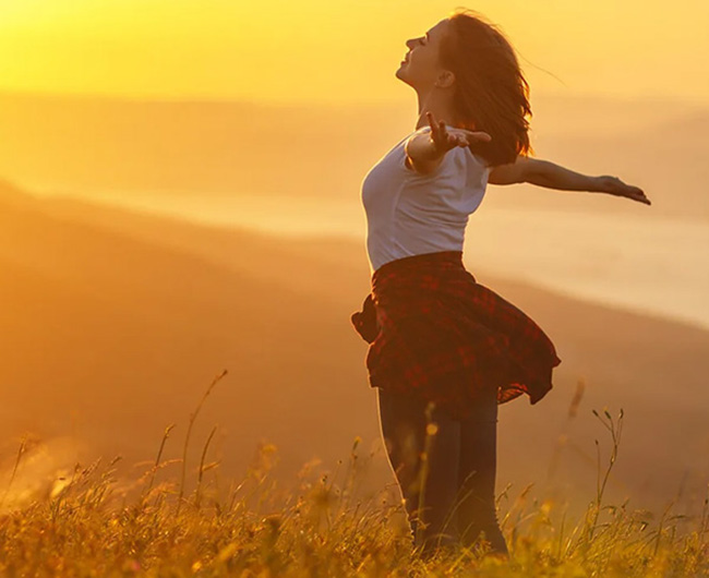 woman greeting the sunrise