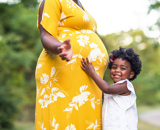 child hugging pregnant woman