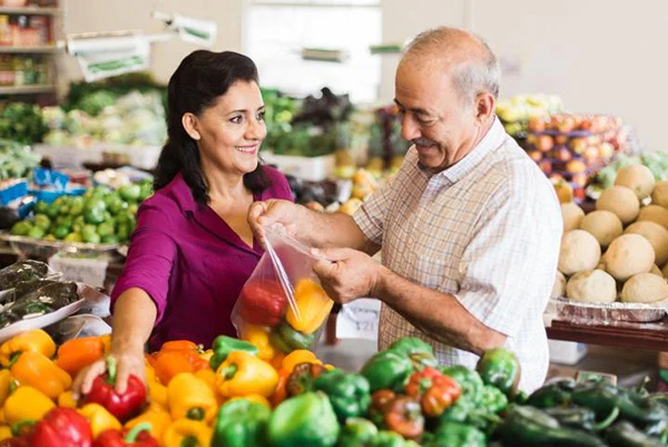 Man and woman grabbing groceries