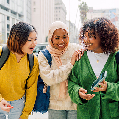 three friends looking at phone