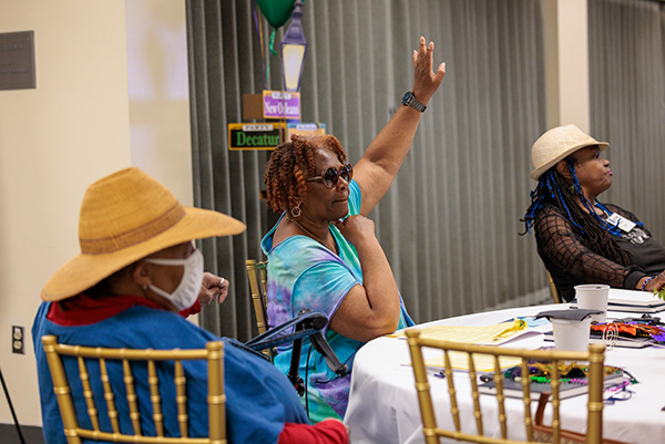 L.A. Care member raising hand at a meeting