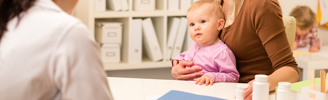 Young woman with baby girl visit pediatrician office for medical check-up